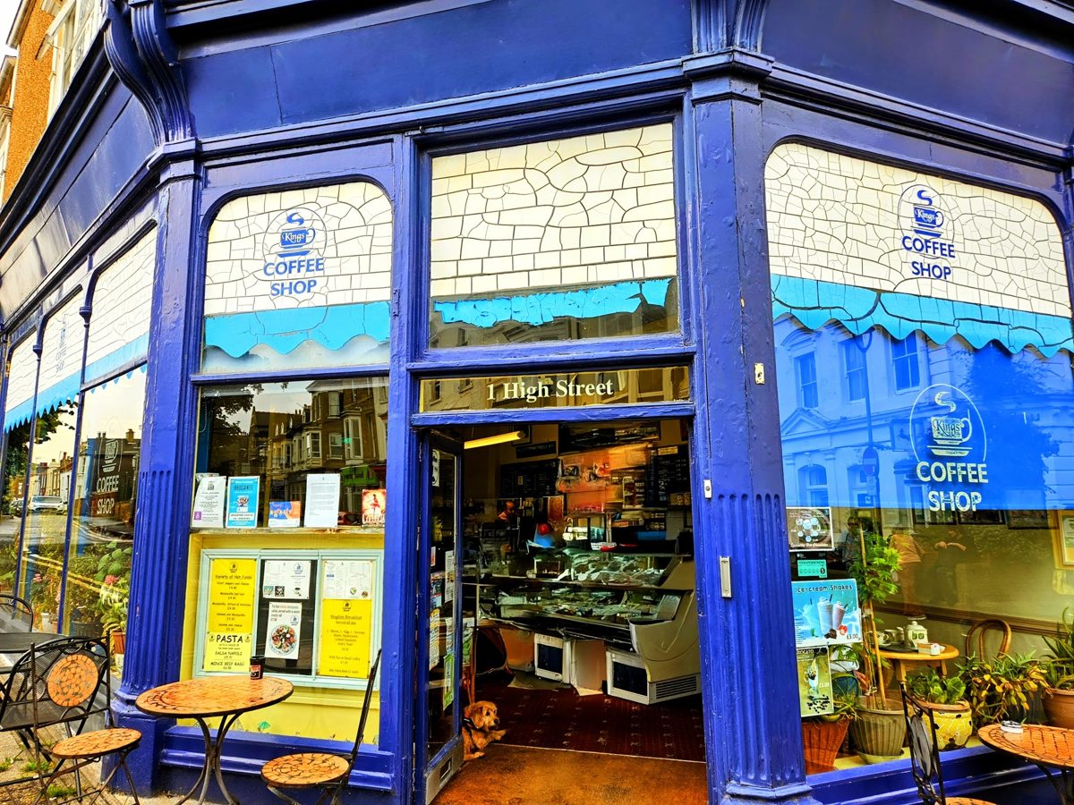 The blue-painted shopfront with tables outside